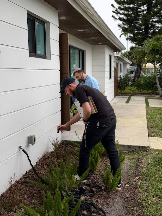 Dever Pest technician inspecting a Miami yard for mosquito breeding sites