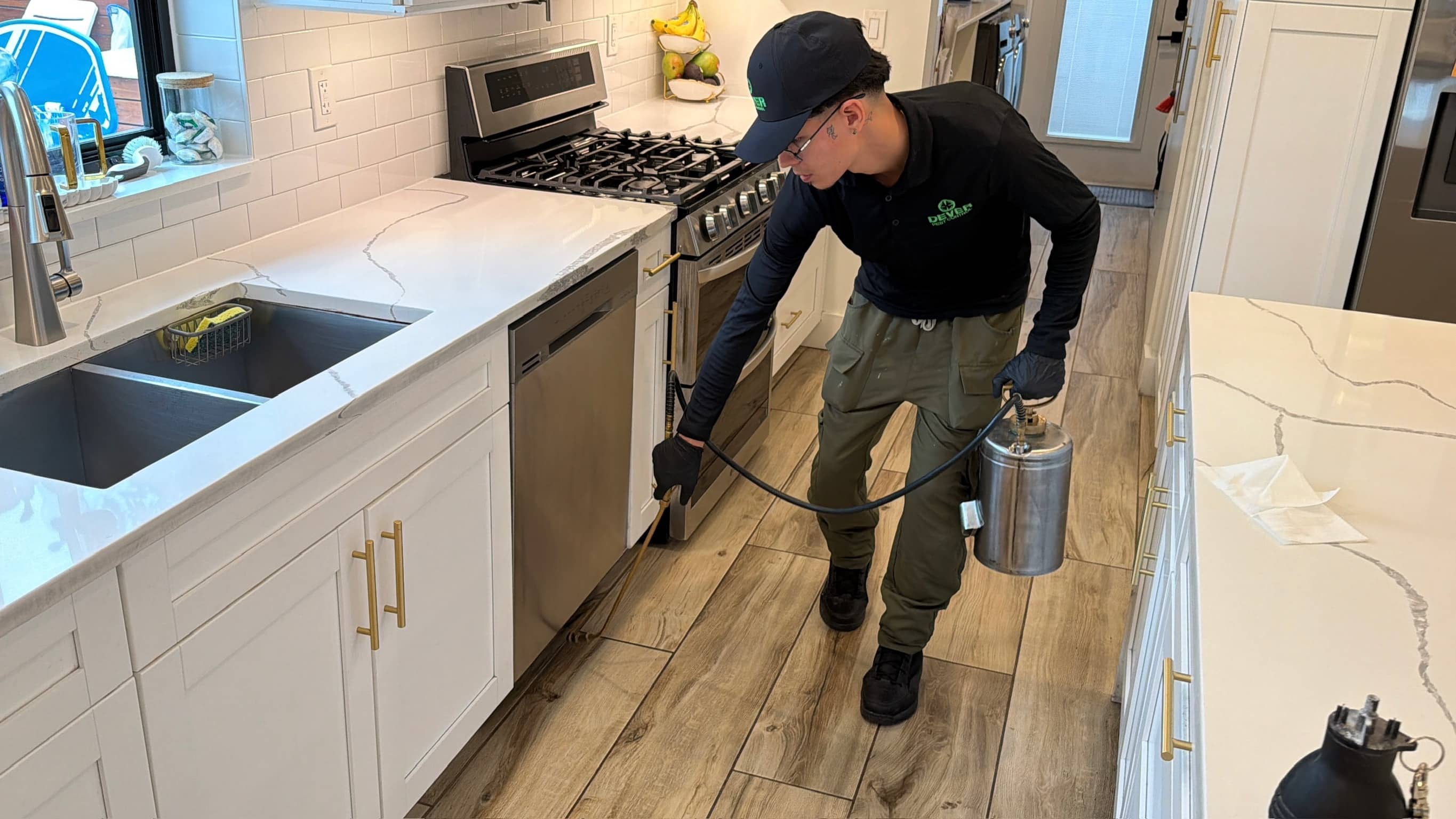 Dever Pest Control technician treating a Miami kitchen